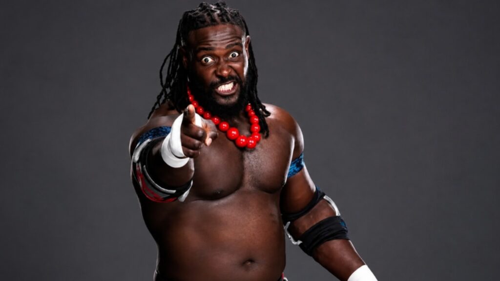 Oba Femi standing in the ring showing his imposing physique and beard