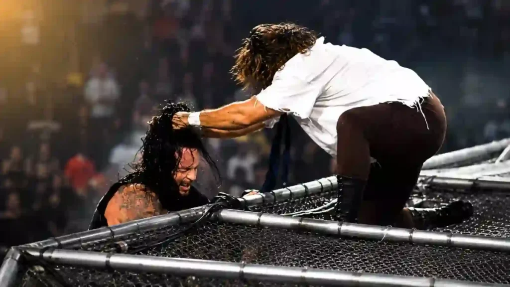 Dramatic wrestling action on top of a steel cage during a high-risk match