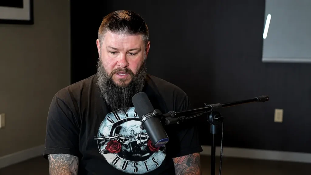AI illustration of Kevin Owens speaking during a podcast interview in a professional recording studio with a broadcast microphone.
